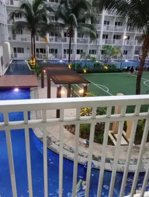 a view of the pool from the balcony of a hotel at LJ&LUNA Staycation in Manila