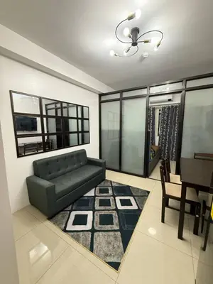 a living room with a couch and a table at LJ&LUNA Staycation in Manila