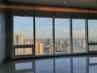 an empty room with a view of a city at Elevated cozy loft studio in Manila