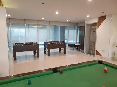a room with a pool table in a building at Elevated cozy loft studio in Manila