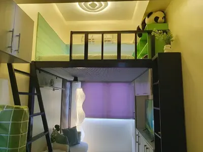 a room with a bunk bed in a room at Elevated cozy loft studio in Manila