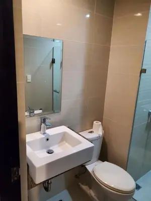 a bathroom with a sink and a toilet and a mirror at 81 Newport Studio C5 5i near NAIA T3 Pool and Balcony in Manila