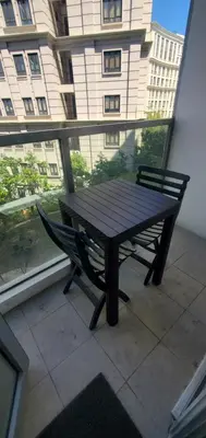 a wooden table and a bench on a balcony at 81 Newport Studio C5 5i near NAIA T3 Pool and Balcony in Manila