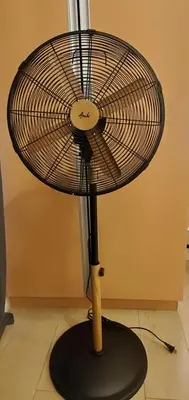 a fan with a wooden stick on a table at 81 Newport Studio C5 5i near NAIA T3 Pool and Balcony in Manila