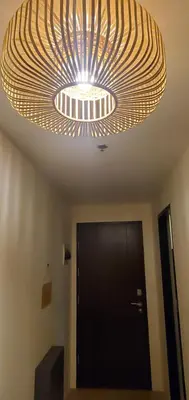 a large light hanging from a ceiling in a room at 81 Newport Studio C5 5i near NAIA T3 Pool and Balcony in Manila