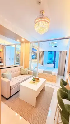 a living room with a couch and a table at Goldleaf Suite at Red Residences with Balcony in Prime Makati Location in Manila