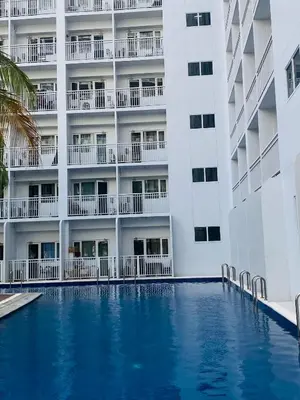 a swimming pool in front of a building at Shore Urban Escape in Manila