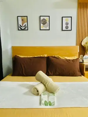 a bedroom with a bed with a towel on it at Shore Urban Escape in Manila