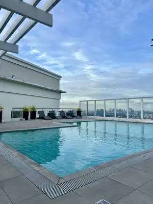 a swimming pool on the roof of a building at High and Cozy Vista Shaw in Manila