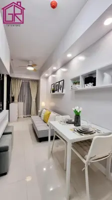 a living room with a white table and a couch at Stylish Modern Condo at Shore Residences MOA in Manila