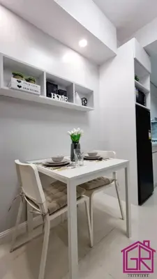 a white dining room table with two chairs and a table at Stylish Modern Condo at Shore Residences MOA in Manila