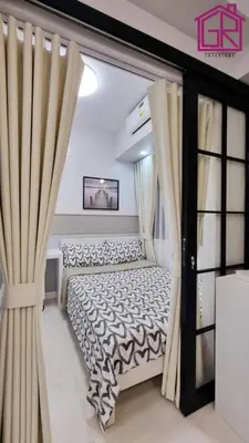 a bedroom with a bed and a window at Stylish Modern Condo at Shore Residences MOA in Manila