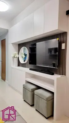 a living room with a microwave and two stools at Stylish Modern Condo at Shore Residences MOA in Manila
