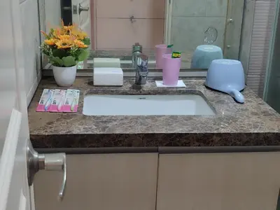 a bathroom counter with a sink and a mirror at BP1637 Facing Pool with Balcony near MOA BP1637 in Manila