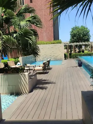 a patio with chairs and a pool in a building at BP1637 Facing Pool with Balcony near MOA BP1637 in Manila