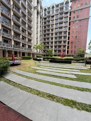 a park in front of a large apartment building at AyenStaycation in Manila