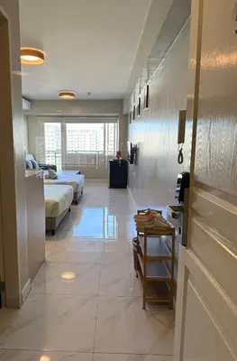 a large room with two beds and a bedroom at AyenStaycation in Manila