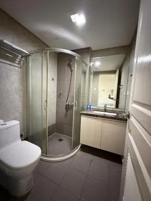 a bathroom with a shower and a toilet and a sink at AyenStaycation in Manila