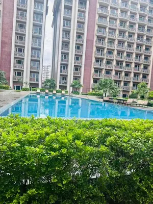 a swimming pool in front of a large building at AyenStaycation in Manila