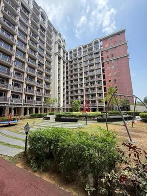 a large apartment complex with two tall buildings at AyenStaycation in Manila