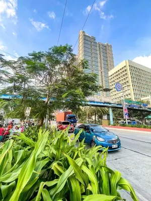 a blue car parked on the side of a street with buildings at Spacious 3BR near US Embassy, Manila Ocean Park in Manila