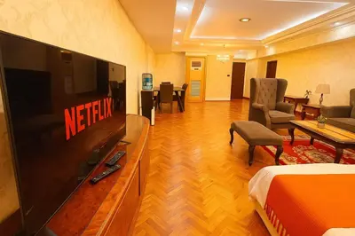 a hotel room with a television and a living room at Spacious 3BR near US Embassy, Manila Ocean Park in Manila