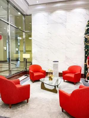 a lobby with red chairs and a table at Spacious 3BR near US Embassy, Manila Ocean Park in Manila