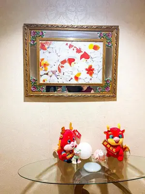 two toy figurines on a glass table in front of a picture at Elegant 2BR Manila Bay Sunset near US Embassy in Manila