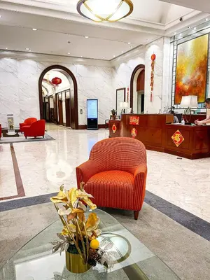 a lobby with a red chair and a table at Elegant 2BR Manila Bay Sunset near US Embassy in Manila