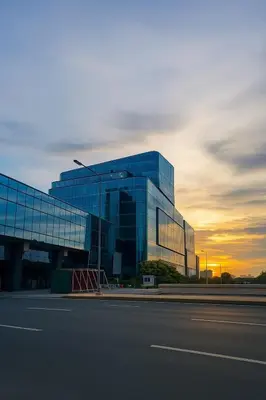 a large glass building with a sunset in the background at Lovely 1BR w Sunset near Solaire, Okada, Airport in Manila