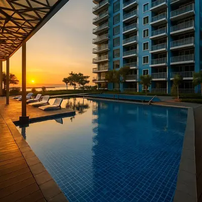 a swimming pool with a sunset in the background at Elegant 1BR near Solaire, Okada, Mall of Asia in Manila