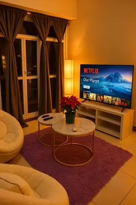 a living room with a tv and a table at Elegant 1BR near Solaire, Okada, Mall of Asia in Manila