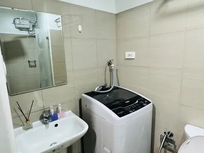 a bathroom with a sink and a washing machine at Shore 2 Residences Room 360 POOL VIEW by Prime Stay MOA in Manila
