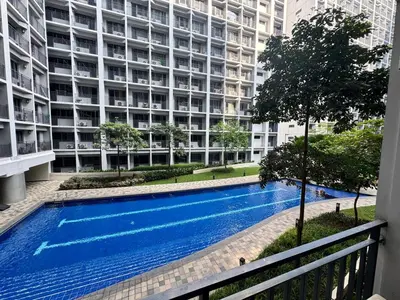 a swimming pool in front of a large building at Shore 2 Residences Room 360 POOL VIEW by Prime Stay MOA in Manila