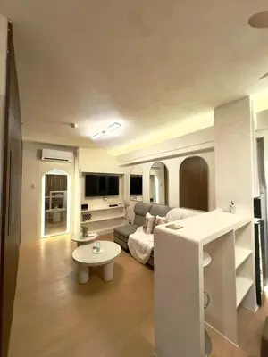 a living room with a couch and a table at Taguig, near BGC Staycation in Manila