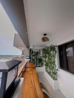 a room with a wooden floor and plants on the walls at Taguig, near BGC Staycation in Manila