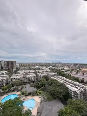 an overhead view of a city with two pools and buildings at Taguig, near BGC Staycation in Manila