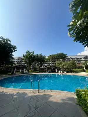 a large blue swimming pool with buildings in the background at Taguig, near BGC Staycation in Manila