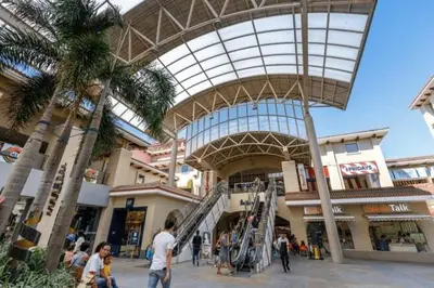 a group of people walking around a shopping mall at Stunning flat in Alabang in Manila
