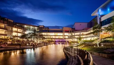 a river in front of a building at night at Stunning flat in Alabang in Manila