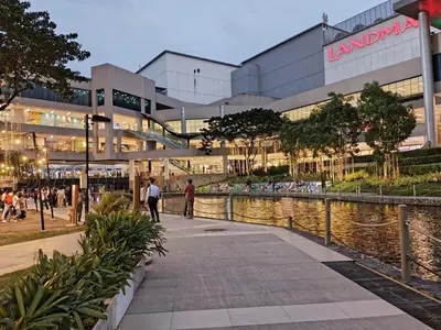 a large building with a river in front of it at Stunning flat in Alabang in Manila