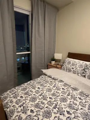 a bedroom with a bed and a window at Stunning flat in Alabang in Manila
