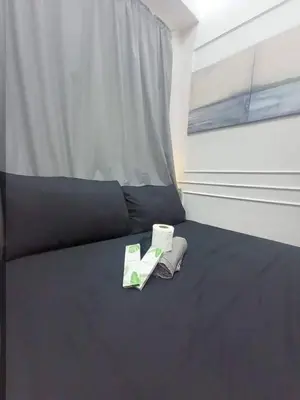 a bedroom with a bed with two towels and a window at Cozy Couple Room near mall of asia in Manila