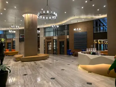 a lobby with a reception desk in a building at Furnished Studio in Knightsbridge Residences in Manila