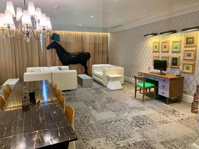 a living room with a table and a horse statue at Furnished Studio in Knightsbridge Residences in Manila