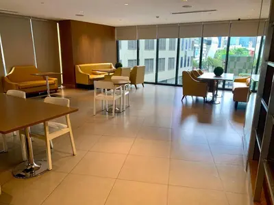 a restaurant with tables and chairs and a large window at Furnished Studio in Knightsbridge Residences in Manila