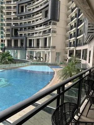 a balcony with a swimming pool and a building at Furnished Studio in Knightsbridge Residences in Manila