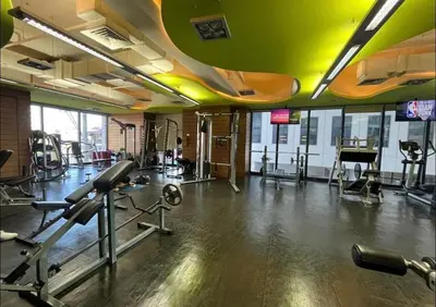 a gym with treadmills and machines in a room at Furnished Studio in Knightsbridge Residences in Manila