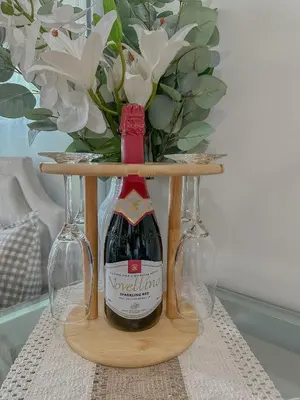 a bottle of wine on a table with two glasses at The Sandscape Suite in Manila