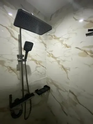 a lamp in a bathroom with a white marble wall at BuenaSentro Hostel in Manila